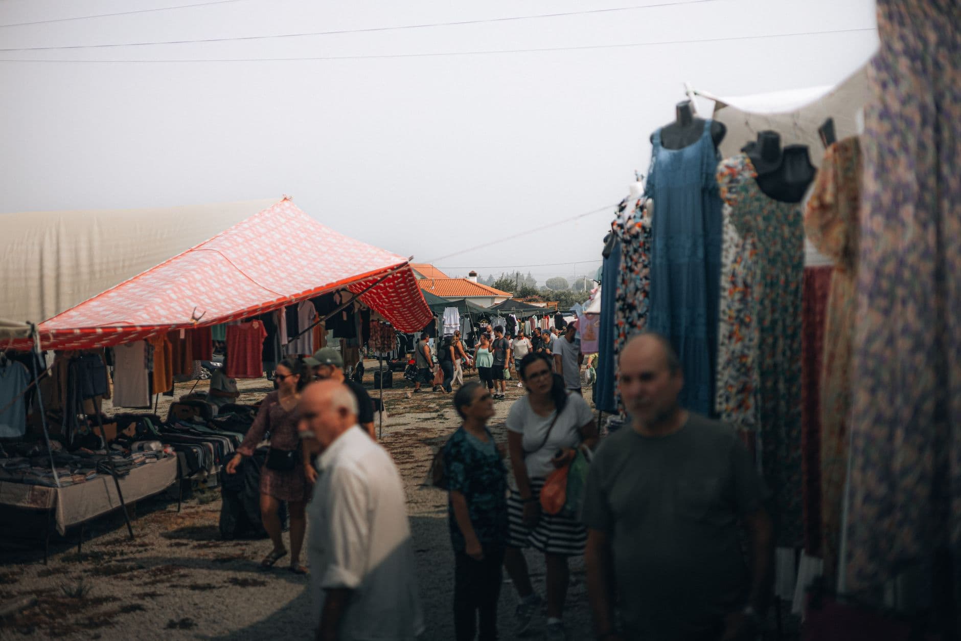 People walking through stalls at Feira de Santa Iria in Faro, Algarve