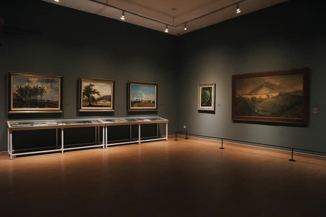 Visitors exploring the landscape art exhibition at Museu Municipal de Faro in Faro, Algarve