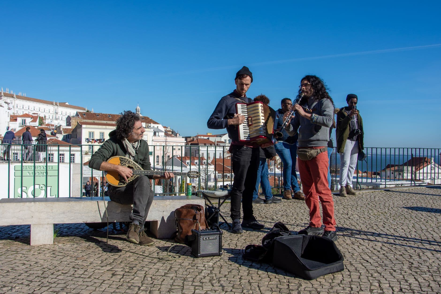 Musicians performing live fado music with traditional instruments in Faro, Algarve