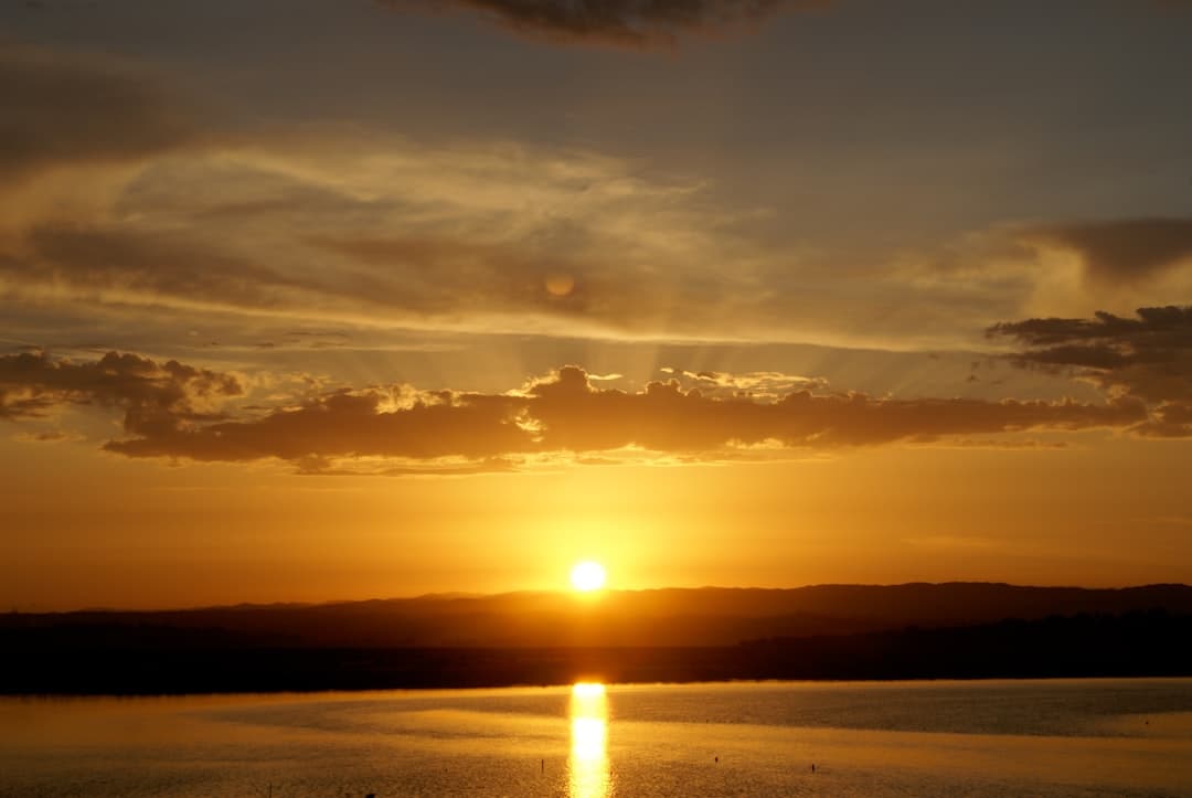 body of water during sunset