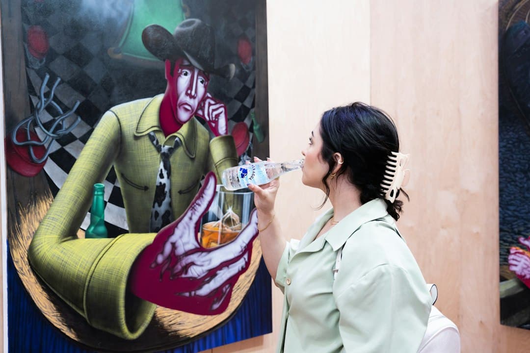 Visitor viewing paintings by Pepe Gámez at an art exhibition in Alcoutim, Algarve